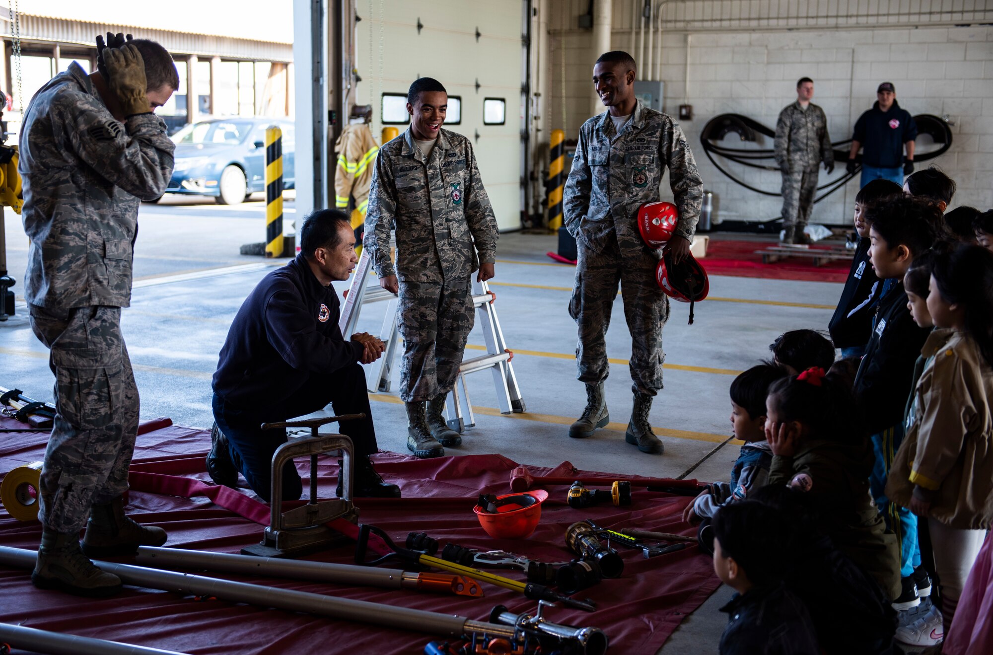 Members from the 8th Civil Engineering Squadron fire department show students from Su Song Elementary various tools they use to accomplish their mission at Kunsan Air Base, Republic of Korea, Oct. 11, 2018. This large array of equipment enables the fire fighters to effectively respond to fire emergencies and save lives. (U.S. Air Force photo by Senior Airman Stefan Alvarez)