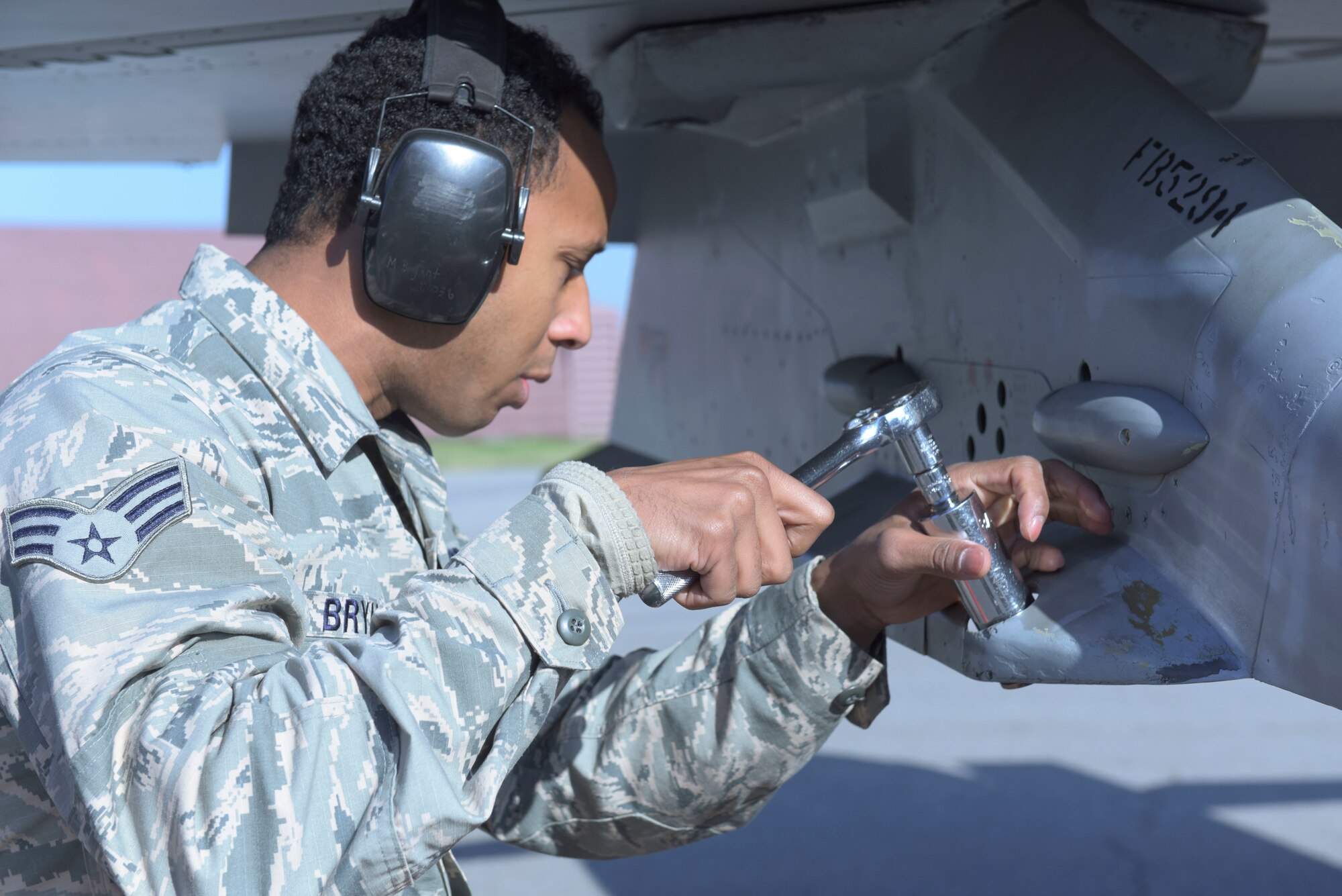U.S. Air Force Senior Airman Javon Bryant, a weapons load crew member with the 51st Aircraft Maintenance Squadron, tightens a bolt on a NF-16 Fighting Falcon panel during a load crew competition at Osan Air Base, Oct. 12, 2018. Air Force maintenance squadrons conduct routine competitions to test a crew’s ability to accurately and safely load munitions onto an aircraft. (U.S. Air Force photo by Staff Sgt. Timothy Dischinat)