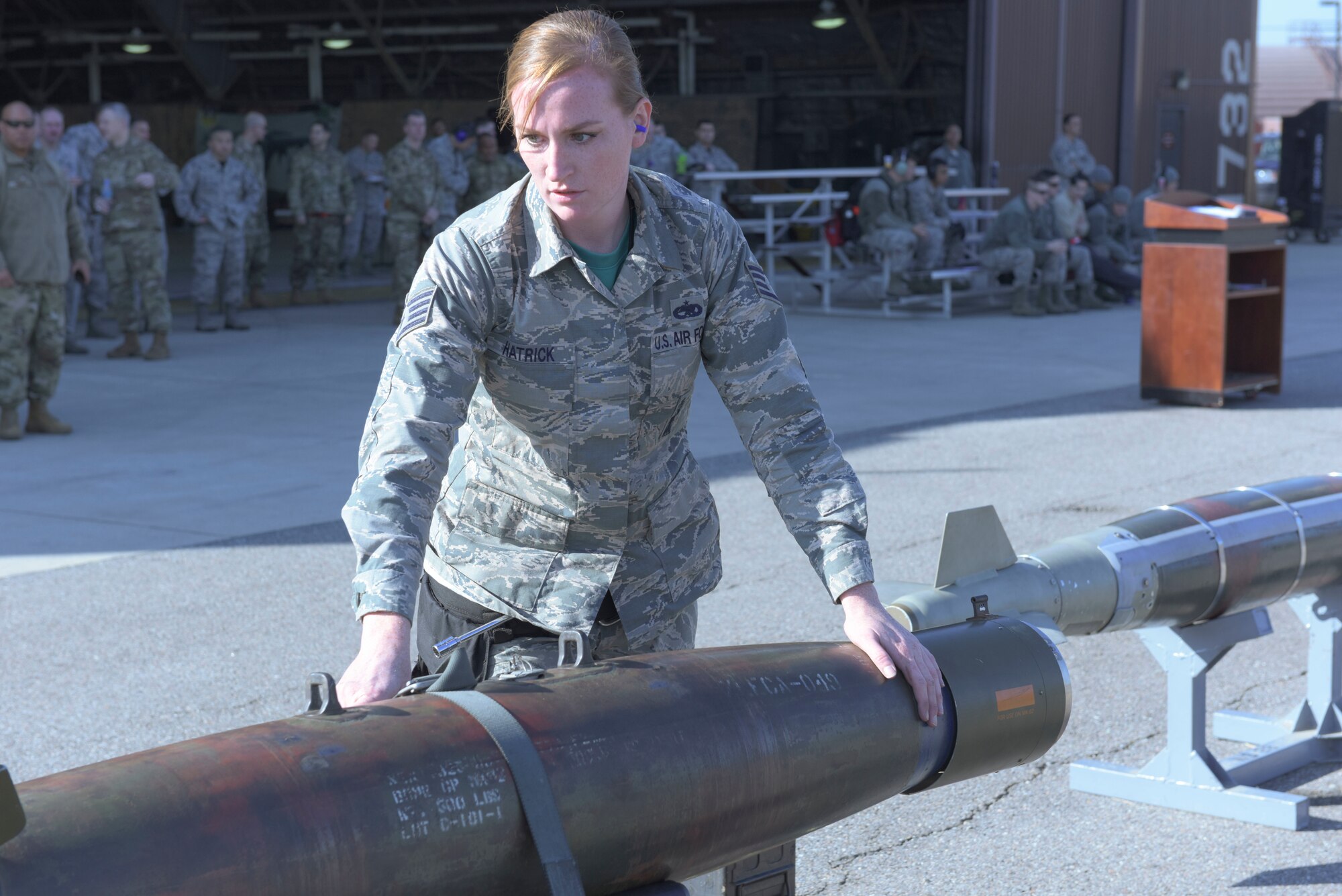 U.S. Air Force Staff Sgt. Cally Hatrick, a weapons load crew member with the 51st Aircraft Maintenance Squadron. inspects a GBU-12 during a load crew competition at Osan Air Base, South Korea, Oct. 12, 2018. Air Force maintenance squadrons conduct routine competitions to test a crew’s ability to accurately and safely load munitions onto an aircraft. (U.S. Air Force photo by Staff Sgt. Timothy Dischinat)