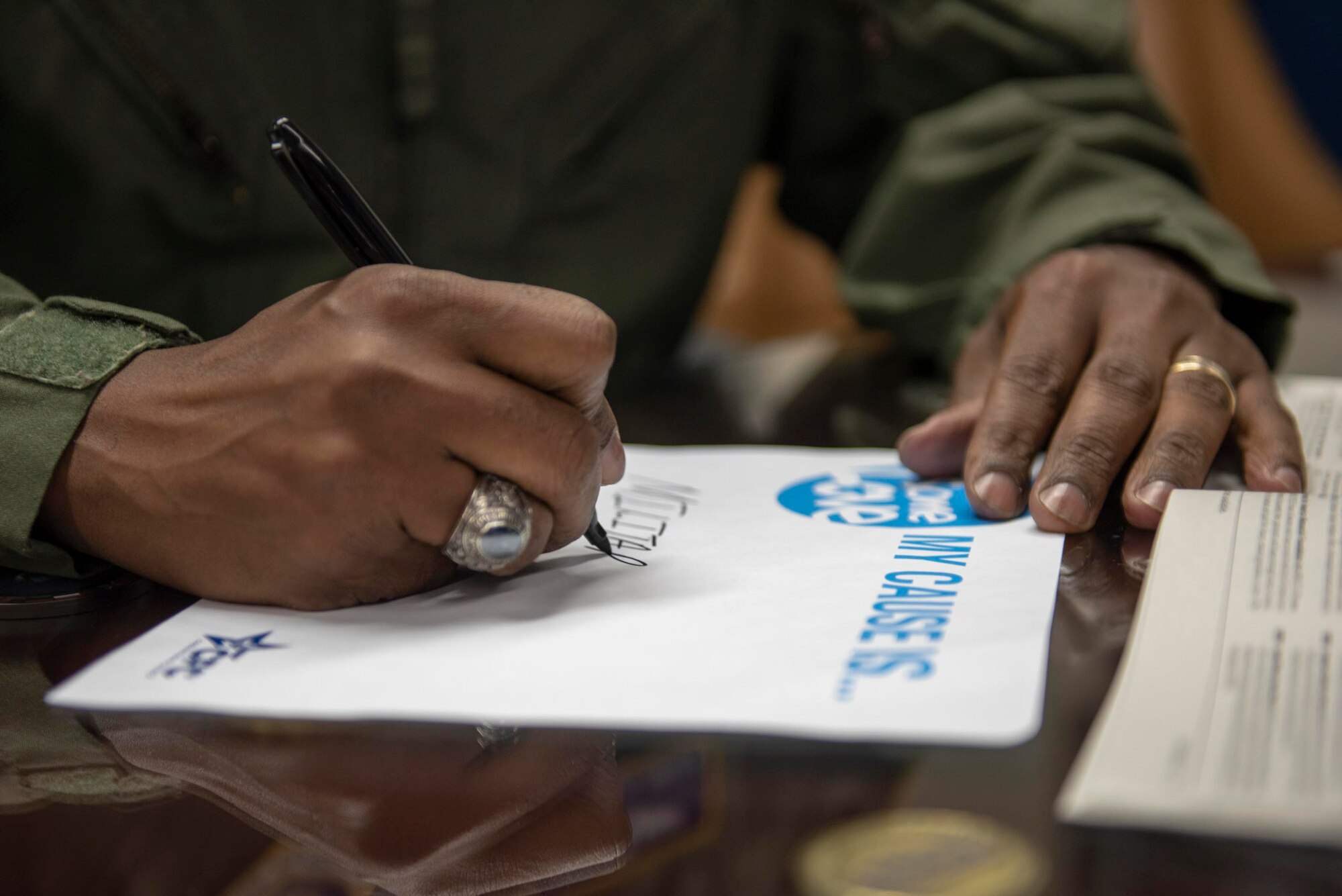 Col. Otis C. Jones, 374th Airlift Wing commander, writes out the cause he will contributing to during the Combined Federal Campaign at Yokota Air Base, Japan, Oct. 12, 2018.