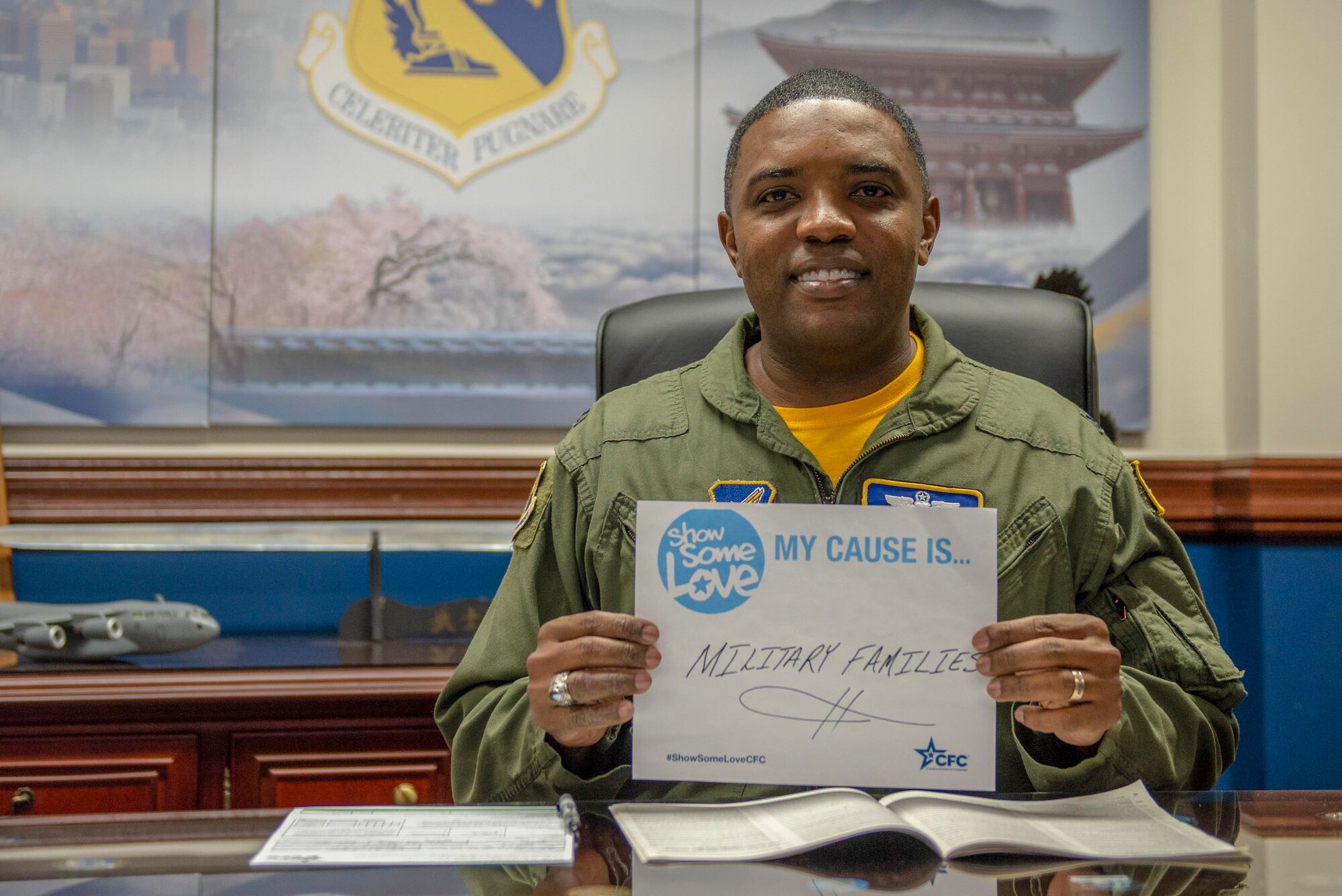 Col. Otis C. Jones, 374th Airlift Wing commander, poses for a photo with his cause of “Military Families” prior to the official kick off of the Combined Federal Campaign at Yokota Air Base, Japan, Oct. 10, 2018.