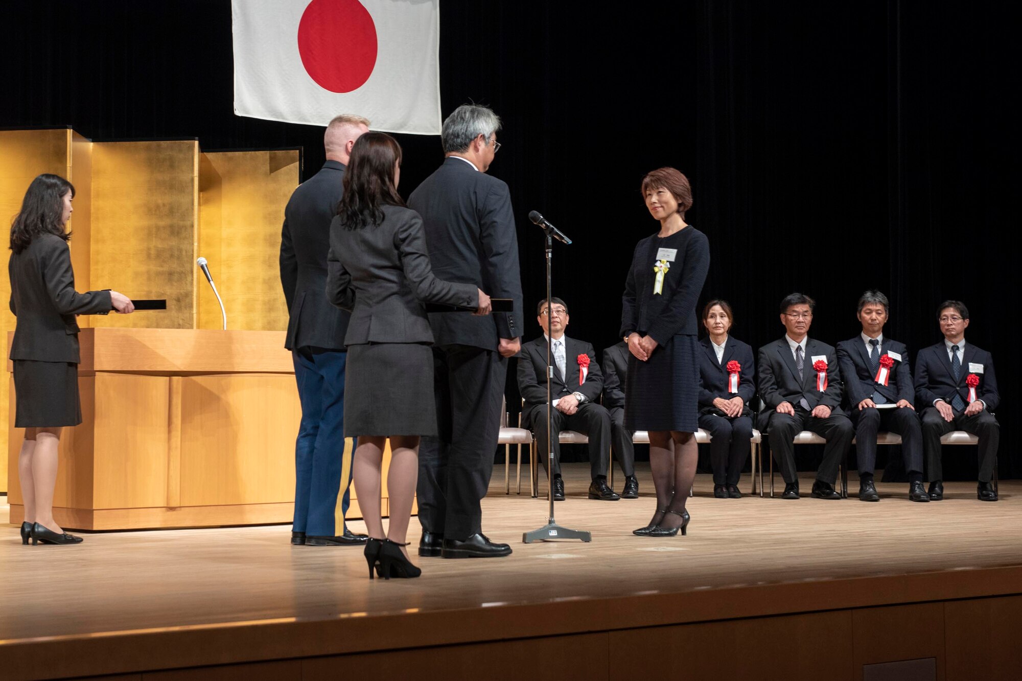 Rie Miyoshi, Stars and Stripes Tokyo management analyst, prepares to receive her award for her years of service during the USFJ Length-of-Service Awards Ceremony at the Yutorogi Hall in Hamura City, Japan, Oct. 10, 2018.