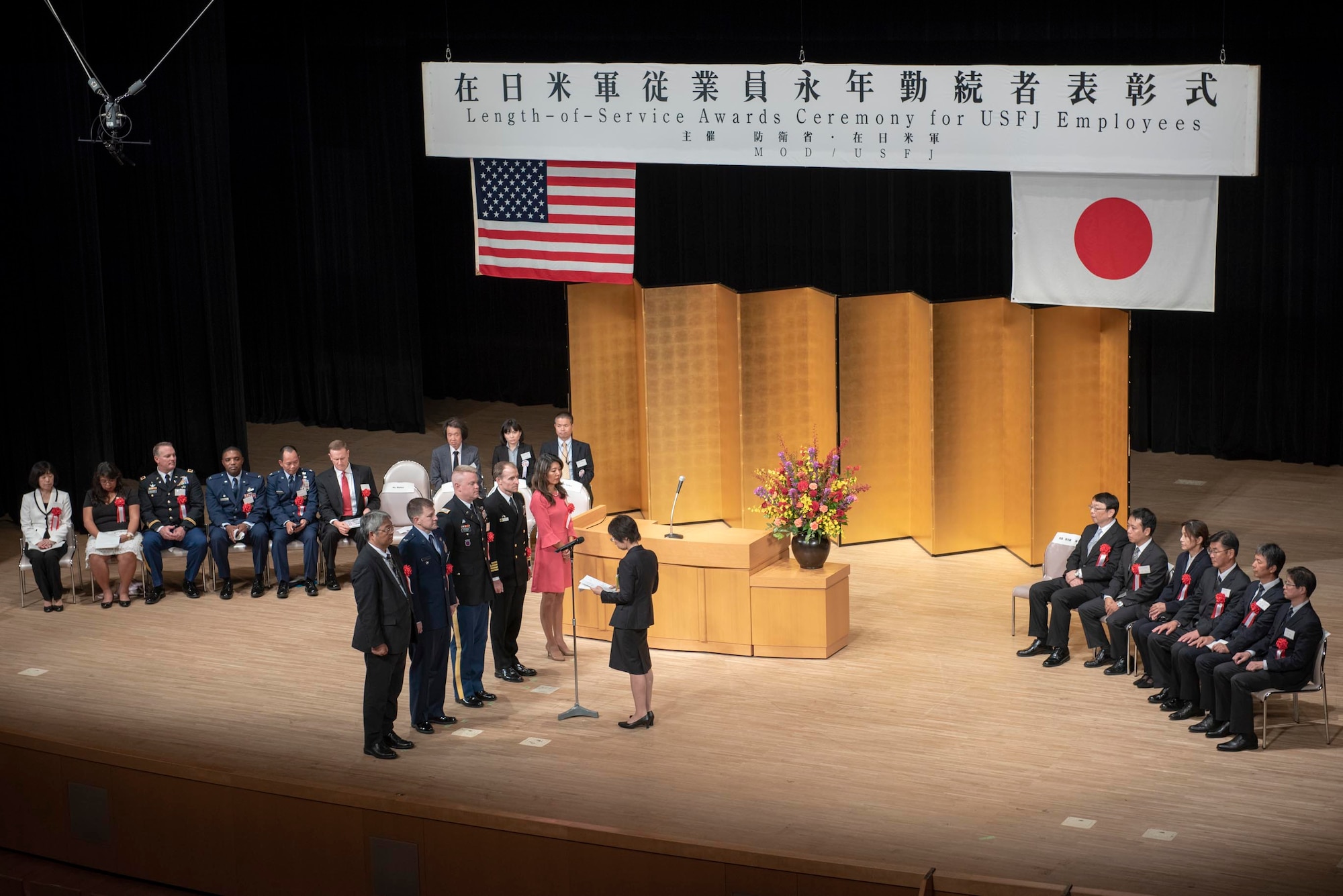 Reiko Ota, 374th Airlift Wing Chaplain administrative specialist, provides the thank you speech on behalf of all award recipients at the USFJ Length-of-Service Awards Ceremony at the Yutorogi Hall in Hamura City, Japan, Oct. 10, 2018.