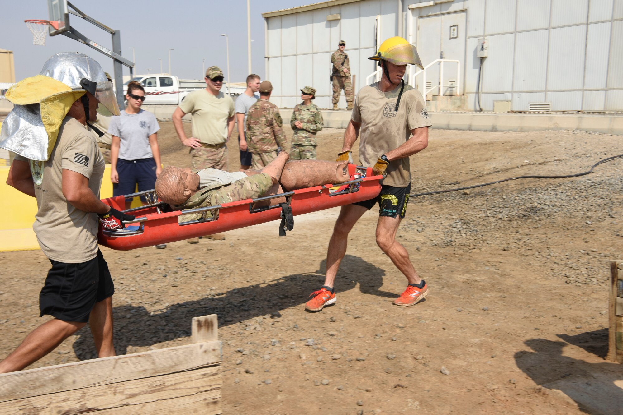 Tech. Sgt. Carlos Oteroflores and Airman 1st Class Christopher Swanson, both assigned to the 380th Aircraft Maintenance Squadron, carry a 250 pound artificial patient during the Fire Muster Competition, Oct. 7, 2018 at Al Dhafra Air Base, United Arab Emirates. The winning team received two $25 gift cards from the BX, a shirt, patches and a coin from the firefighter department. (U.S. Air Force photo by Tech. Sgt. Darnell T. Cannady)