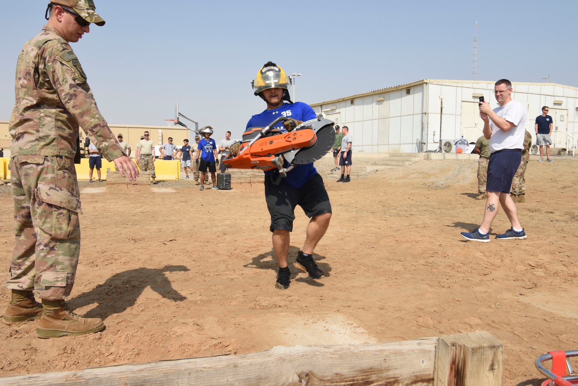 Senior Airman Engel Placencia-Valdez, 380th Expeditionary Security Forces Squadron, carries firefighting equipment during the Fire Muster Competition, Oct. 7, 2018 at Al Dhafra Air Base, United Arab Emirates. Each two-person team were timed while competing in various physically demanding events including bucket brigade, equipment carry, 250 pound drag, tire flips, ladder climb, hose advancement and fire attack. (U.S. Air Force photo by Tech. Sgt. Darnell T. Cannady)
