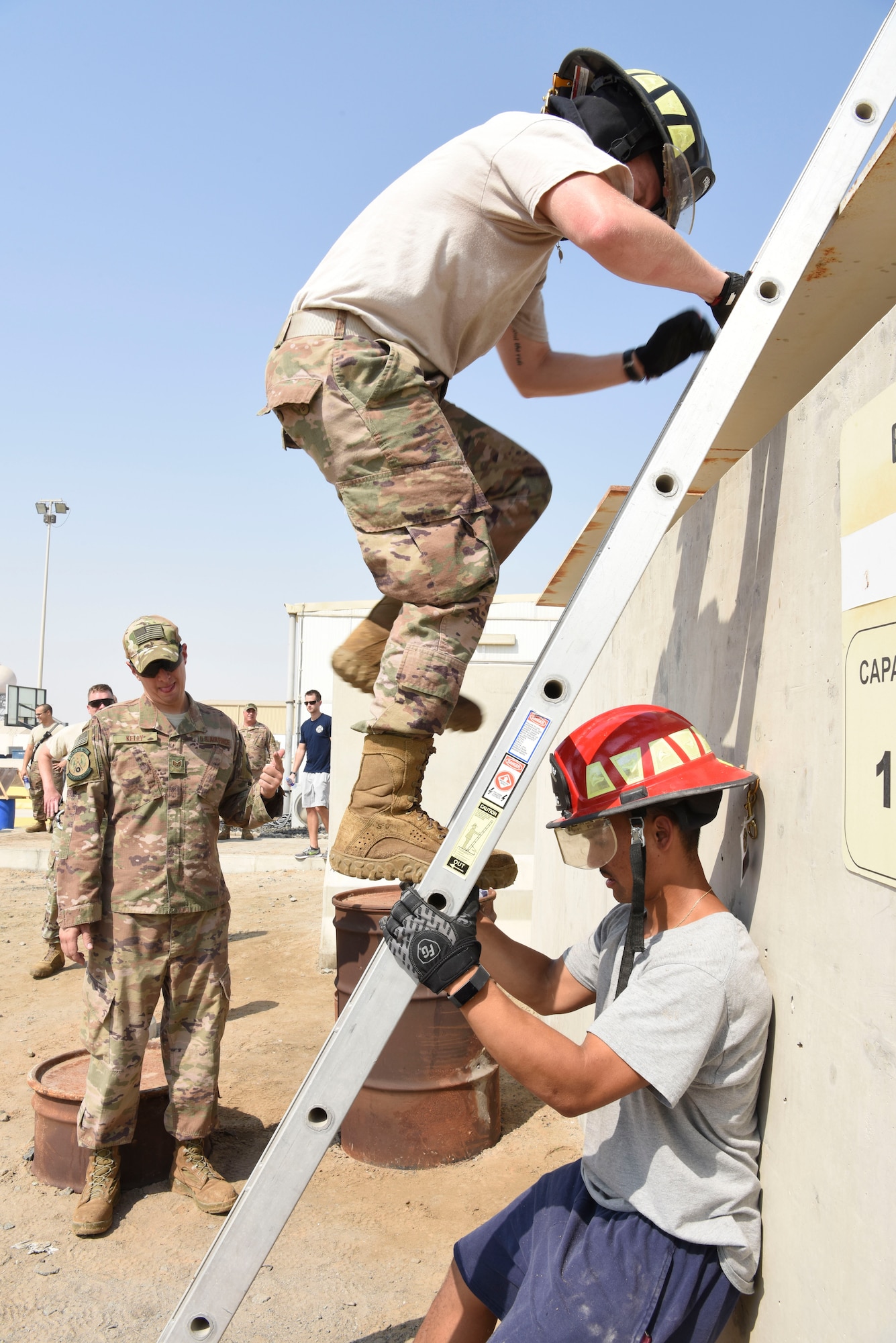 Chief Master Sgt. Bradley Beaty, 380th Expeditionary Civil Engineer Squadron, climbs a ladder during the Fire Muster Competition, Oct. 7, 2018 at Al Dhafra Air Base, United Arab Emirates. The fire muster is a fire fighter event held every year to kick off the fire prevention week campaign. (U.S. Air Force photo by Tech. Sgt. Darnell T. Cannady)