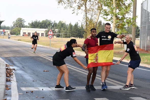 U.S. Air Force Capt. Keven Abraham finishes the Hispanity Day 8K run with a member of the Spanish Army at Incirlik Air Base, Turkey, Oct. 13, 2018.