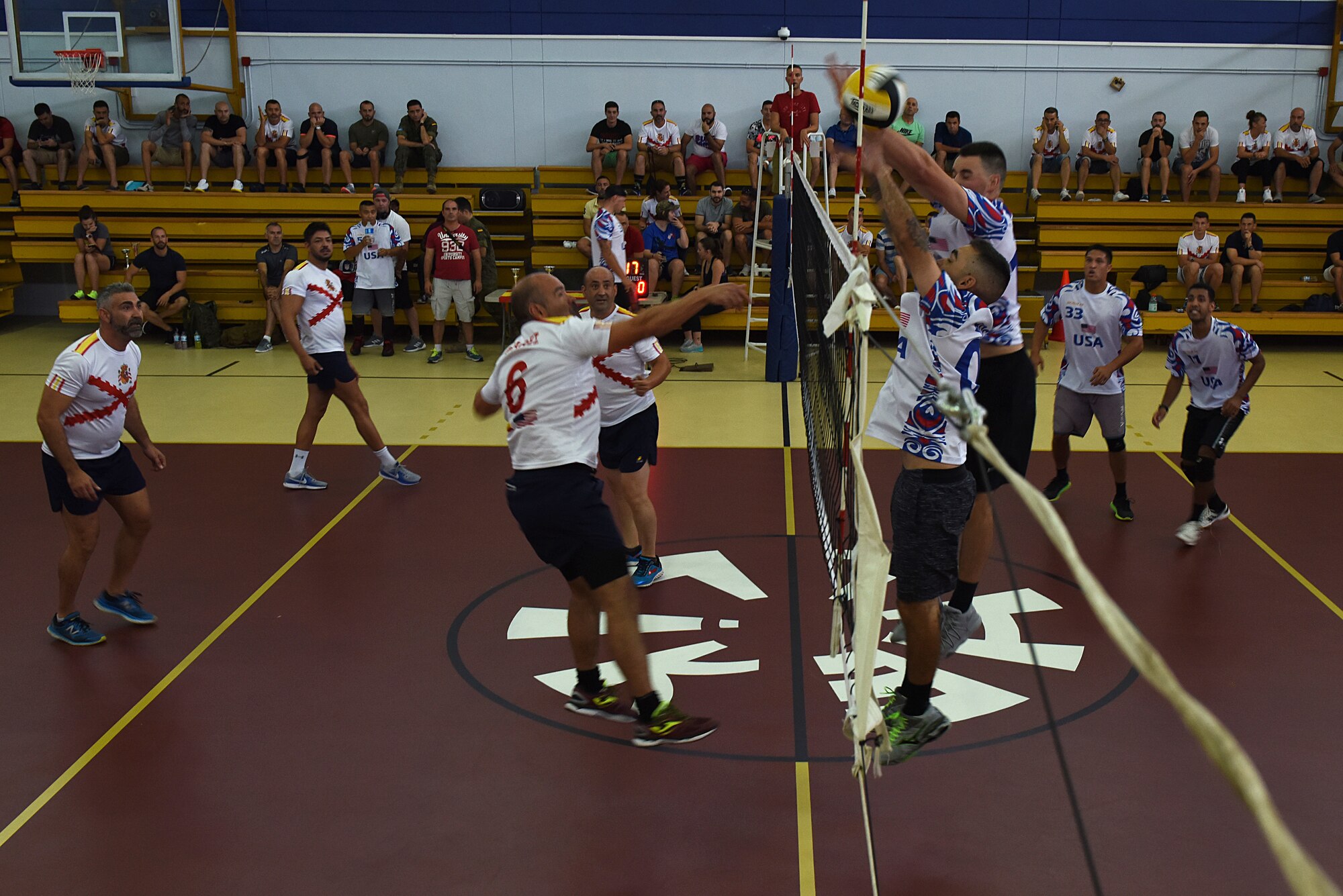 U.S. Air Force and Spanish Army members jump for the volleyball during the Hispanity Day Volleyball Tournament at Incirlik Air Base, Turkey, Oct. 13, 2018.