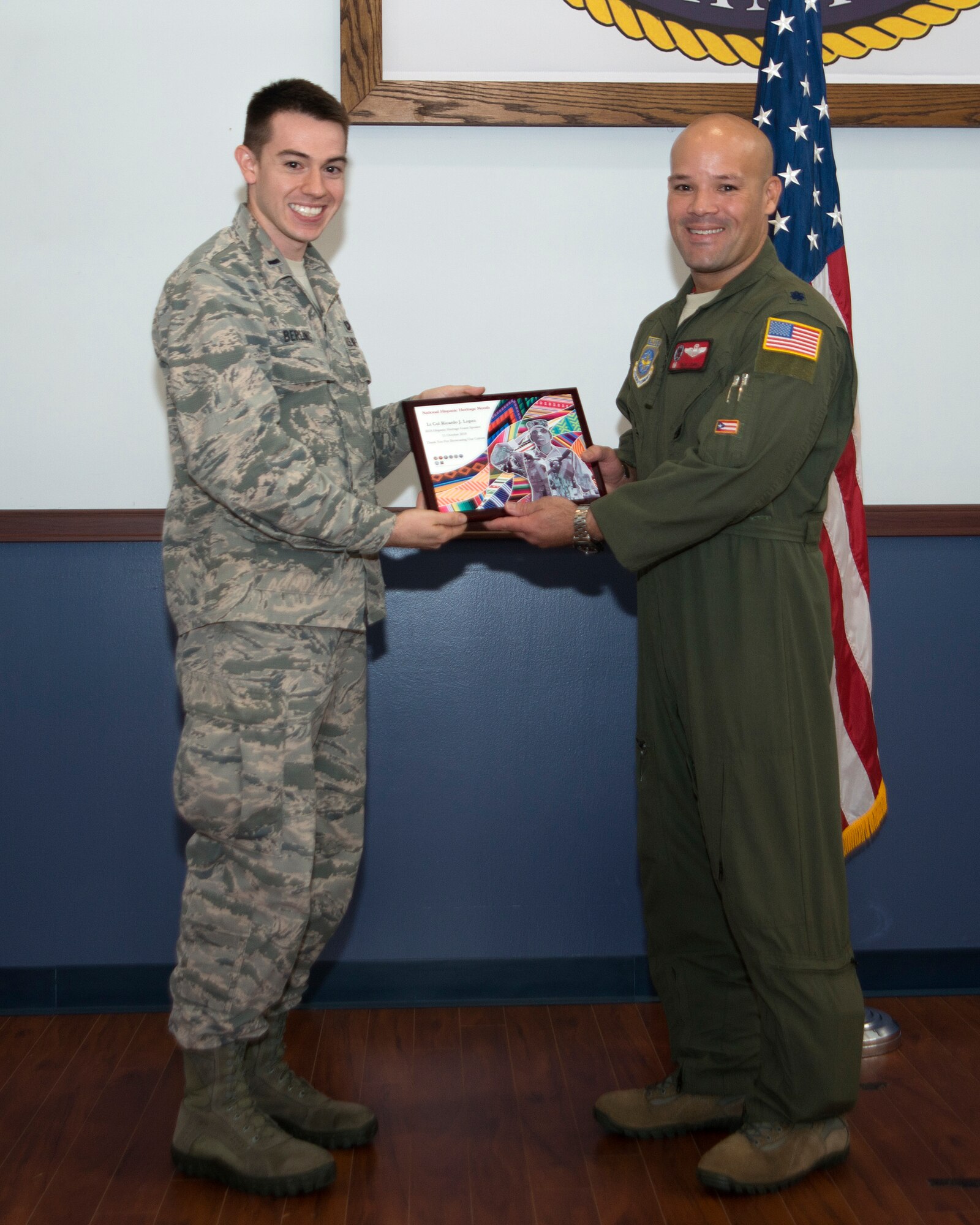 U.S. Air Force Lt. Col. Ricardo Lopez, Commander of the 50th Air Refueling Squadron, accepts an award from 1st Lt. Joseph Berling, a contract manager assigned to the 6th Contracting Squadron, at MacDill Air Force Base, Fla., Oct. 11, 2018.