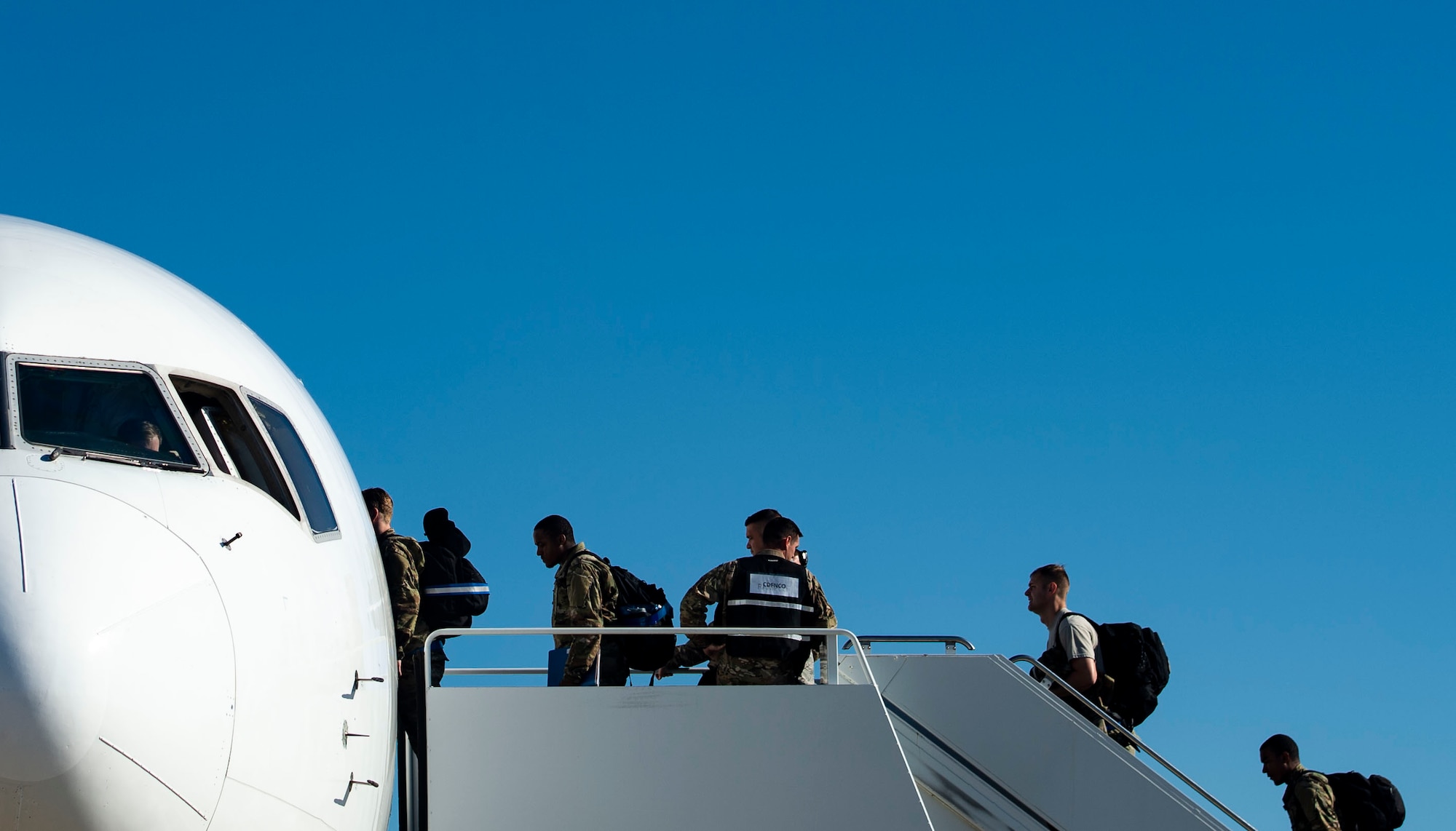 U.S. Airmen assigned to the 55th Fighter Squadron board an airliner at Shaw Air Force Base, S.C., Oct. 13, 2018.