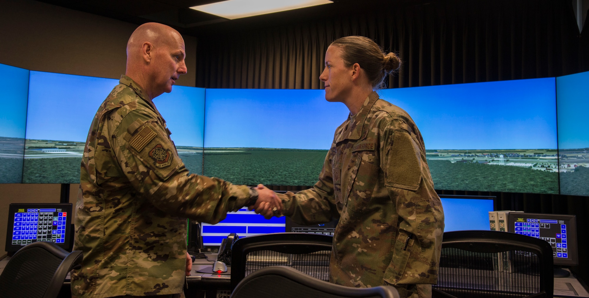 Maj. Gen. Sam Barrett, 18th Air Force commander, coins Master Sgt. Patricia Tate, 375th Operations Support Squadron air traffic controller, Oct.11, 2018, at Scott Air Force Base, Illinois. Tate was coined for being an exceptional performer within the squadron. (U.S. Air Force photo by Airman 1st Class Nathaniel Hudson)