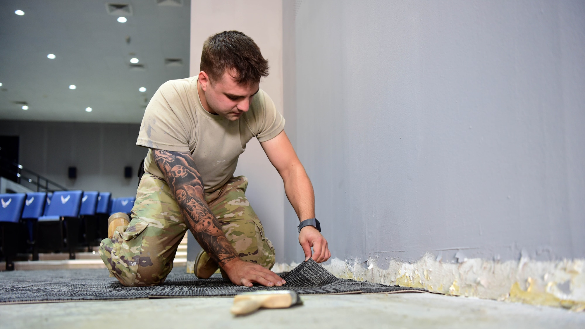 Staff Sgt. Nathan Russian, 386th Expeditionary Civil Engineer Squadron structures journeyman, lays carpet tiles during a building renovation Oct. 10, 2018, at an undisclosed location in Southwest Asia. Russian is this week's Rock Solid Warrior. The Rock Solid Warrior program is a way to recognize and spotlight the Airmen of the 386th Air Expeditionary Wing for their positive impact and commitment to the mission. (U.S. Air Force photo by Staff Sgt. Christopher Stoltz)