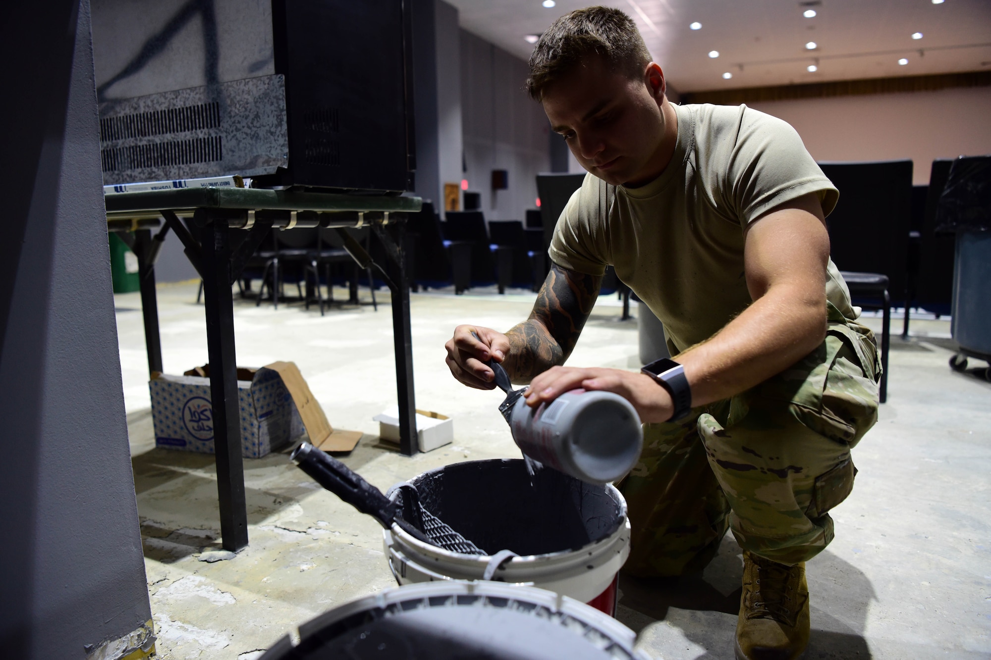 Staff Sgt. Nathan Russian, 386th Expeditionary Civil Engineer Squadron structures journeyman, cleans a paint brush Oct. 10, 2018, at an undisclosed location in Southwest Asia. Russian and his fellow structures journeymen are in the middle of renovating various facilities here at 'the Rock.' (U.S. Air Force photo by Staff Sgt. Christopher Stoltz)