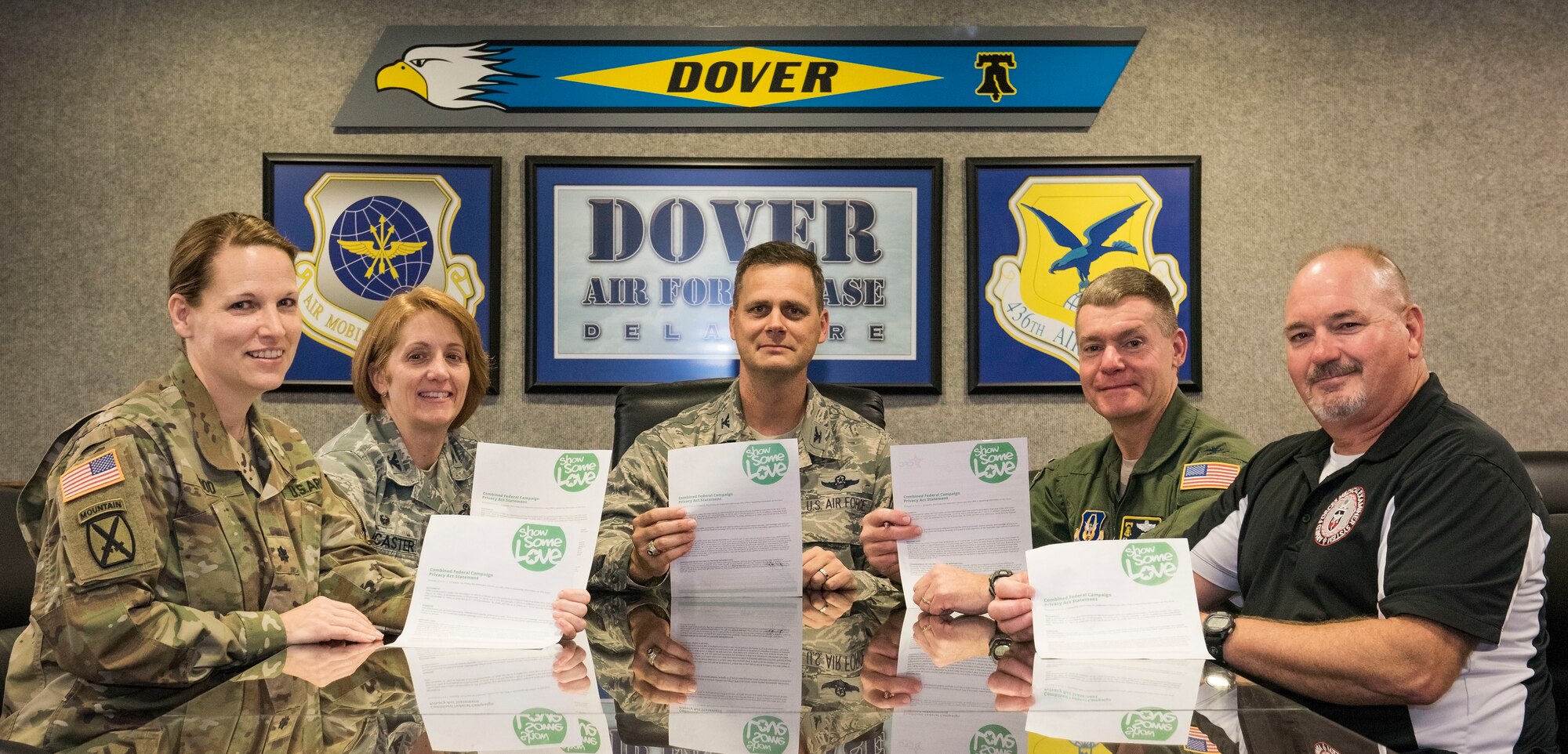 From left, Lt. Col. Laura Wood, Joint Personal Effects Depot commander; Col. Dawn Lancaster, Air Force Mortuary Affairs Operations commander; Col. Joel Safranek, 436th Airlift Wing commander; Col. Craig Peters, 512th Airlift Wing commander; and Rick Gates, Armed Forces Medical Examiner System operations officer, sign their 2018 Combined Federal Campaign pledge forms Oct. 10, 2018, at Dover Air Force Base, Del. The CFC started Oct. 15 and concludes Nov. 16, 2018. Contributions can be made by submitting a paper pledge form or online. (U.S. Air Force photo by Roland Balik)