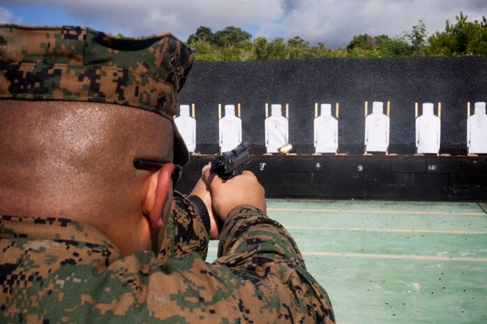 A U.S. Marine with 3rd Law Enforcement Battalion, III Marine Expeditionary Force Intelligence Group fires a Beretta M9 service pistol during pistol qualification at Camp Hansen, Okinawa, Japan, Sept. 6, 2018. Pistol qualification is required annually to sustain the skills of pistol marksmanship.