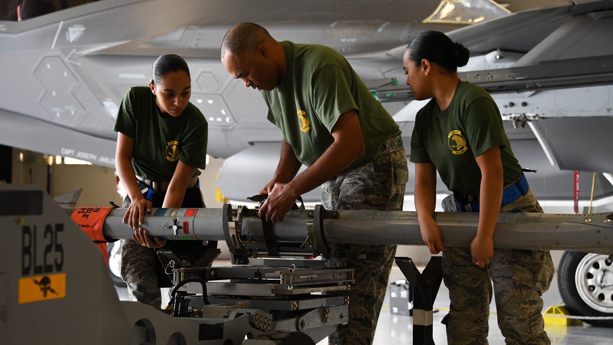 Airmen prepare to load an AIM-9X missile on an F-35A Lightning II during a weapons load competition at Hill Air Force Base, Utah