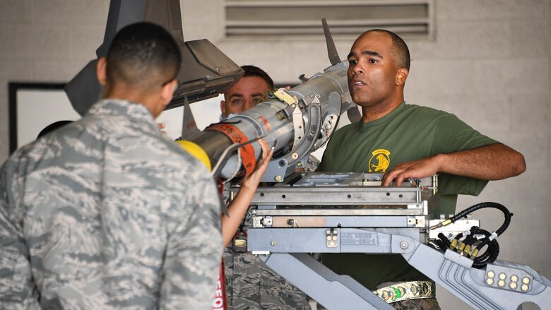 Staff Sgt. William Lewis, 419th Aircraft Maintenance Squadron, secures an AIM-9X missile to the wing of an F-35A Lightning II