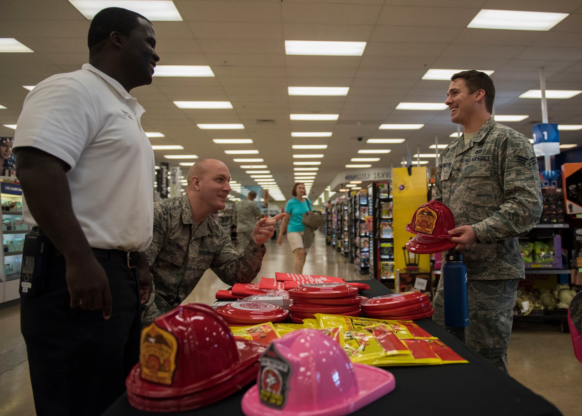 Howard Smith, 633rd Civil Engineer Squadron fire inspector, U.S. Air Force Staff Sgt. Corey Watkins, 633rd CES fire inspector, talk to Senior Airman Jacob Millington, 633rd Force Support Squadron force management apprentice, at Joint Base Langley-Eustis, Virginia, Oct. 9, 2018.