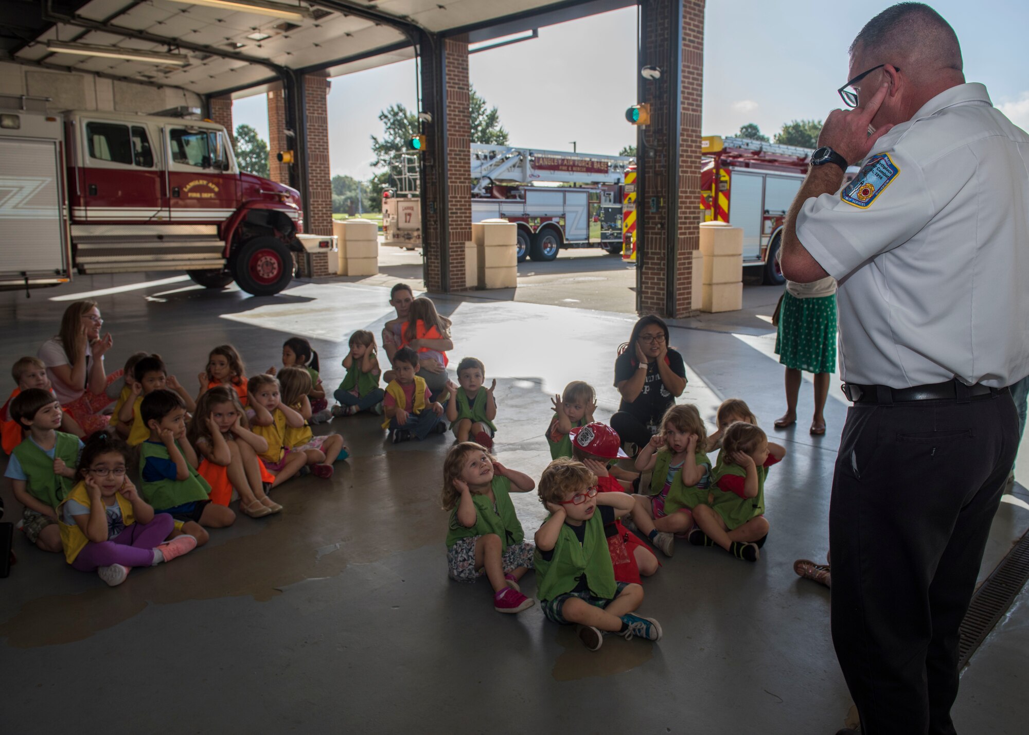 Kenneth Kline, 633rd Civil Engineer Squadron chief of fire prevention, talks to children from the NASA Langley Child Development Center pre-k class at Joint Base Langley-Eustis, Virginia, Oct. 10, 2018.