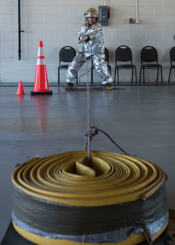 A Fire Prevention Week challenge competitor pulls a fire hose at Joint Base Langley-Eustis, Virginia, Oct. 12, 2018.