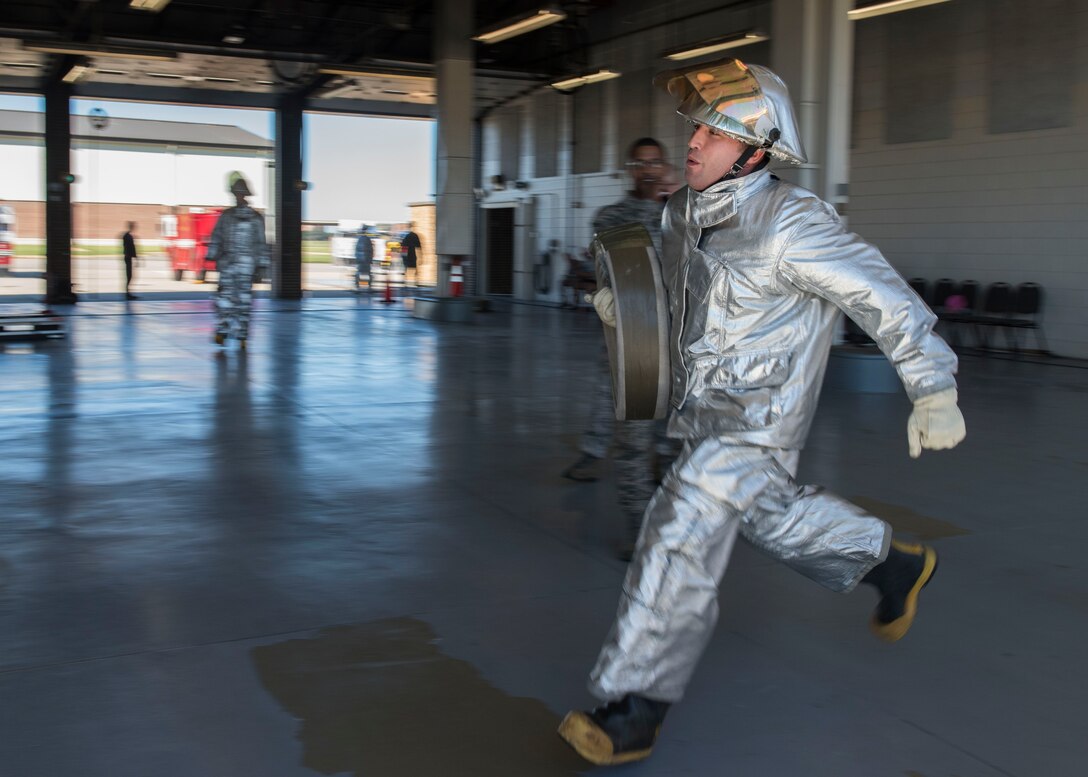 U.S. Air Force Master Sgt. Daniel Linares, 633rd Security Forces Squadron first sergeant, runs with a fire hose during the Fire Prevention Week challenge at Joint Base Langley-Eustis, Virginia, Oct. 12, 2018.