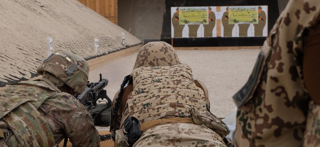 Staff Sergeant Fiorillo being instructed on shooting of the MG3 Heavy machine gun.