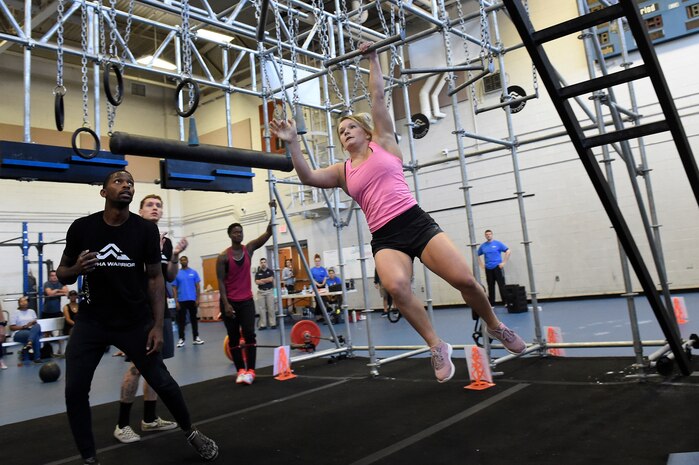 2nd Lt. Darby Germain, a section commander assigned to the 628th Force Support Squadron, swings across the “broken bars” during the Alpha Warrior regional competition Oct. 13, 2018, at Joint Base Charleston, S.C.