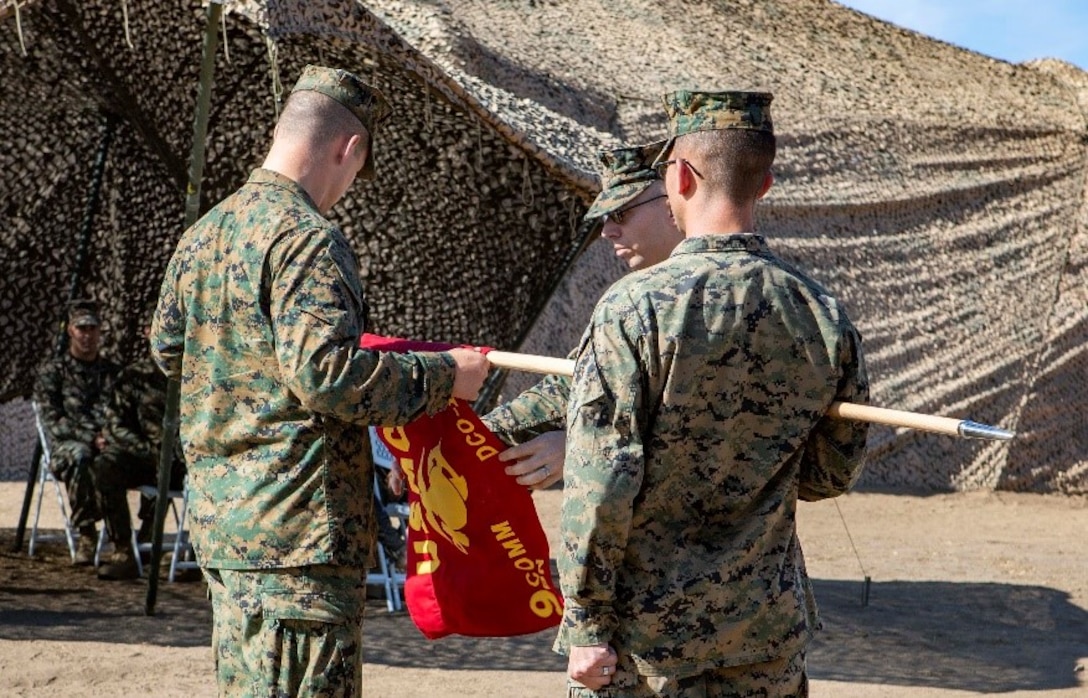 U.S. Marines assigned to Defensive Cyberspace Operations-Internal Defensive Measures Company, 9th Communications Battalion, I Marine Expeditionary Force Information Group, unveil the guidon during the activation ceremony for the DCO Company at Marine Corps Base Camp Pendleton, California, Oct. 1, 2018. The 9th Comm DCO-IDM Company is the first of three such companies the Marine Corps will activate in accordance with Force Modernization 2025. DCO-IDM Company provides added security to the Marine Corps Enterprise Network by executing offensive cyberspace operations to defend the Marine Air-Ground Task Force information networks across all domains. (U.S. Marine Corps photo by Cpl. Cutler Brice)