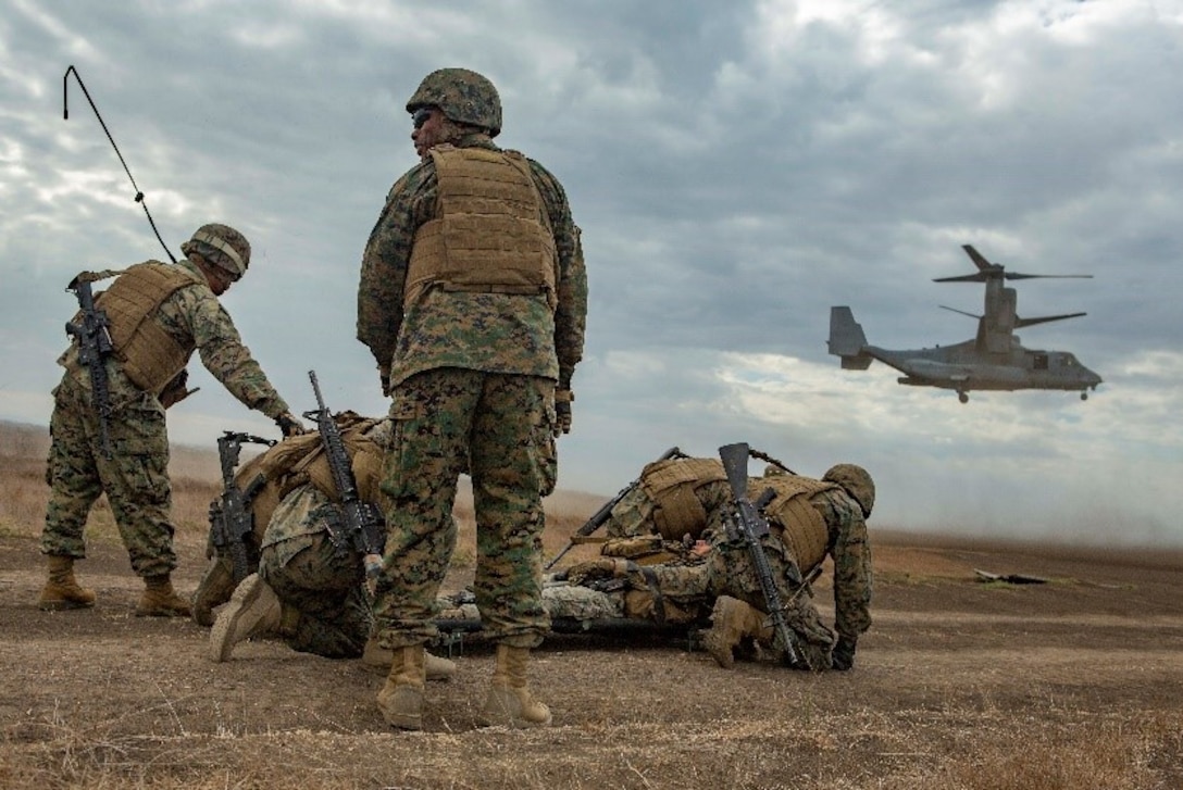 U.S. Marines with Service Company, 9th Communications Battalion, I Marine Expeditionary Force Information Group, prepare to load the simulated casualty as an MV- 22B Osprey lands for a casualty evacuation drill at Marine Corps Base Camp Pendleton, Oct. 2, 2018. The drill was part of a field exercise the battalion executed providing the Marines realistic combat training. (U.S. Marine Corps photo by Cpl. Cutler Brice.)