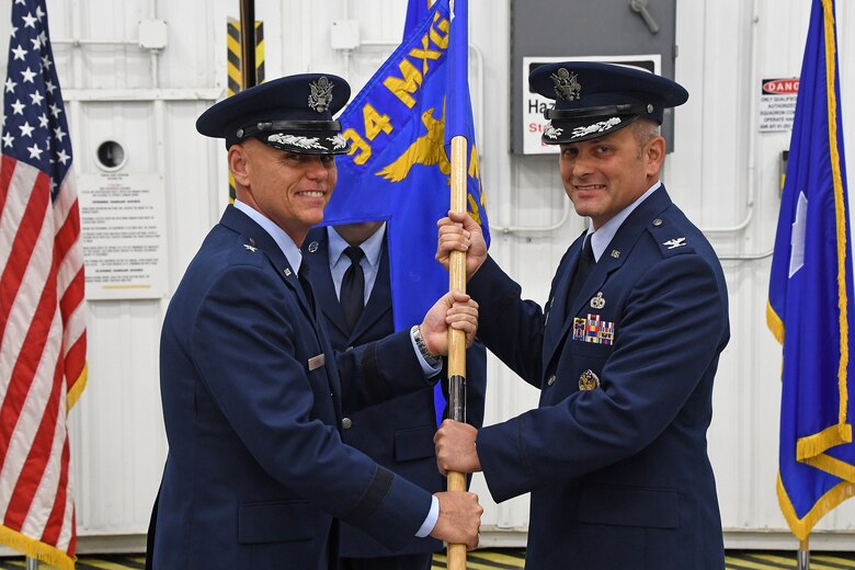 Col. Brad Douglass, right, receives the 94th Maintenance Group guide on from Brig. Gen. Richard Kemble, 94th Airlift Wing commander, during an assumption-of-command ceremony held at Dobbins Air Reserve Base, Georgia on Oct. 13, 2018.