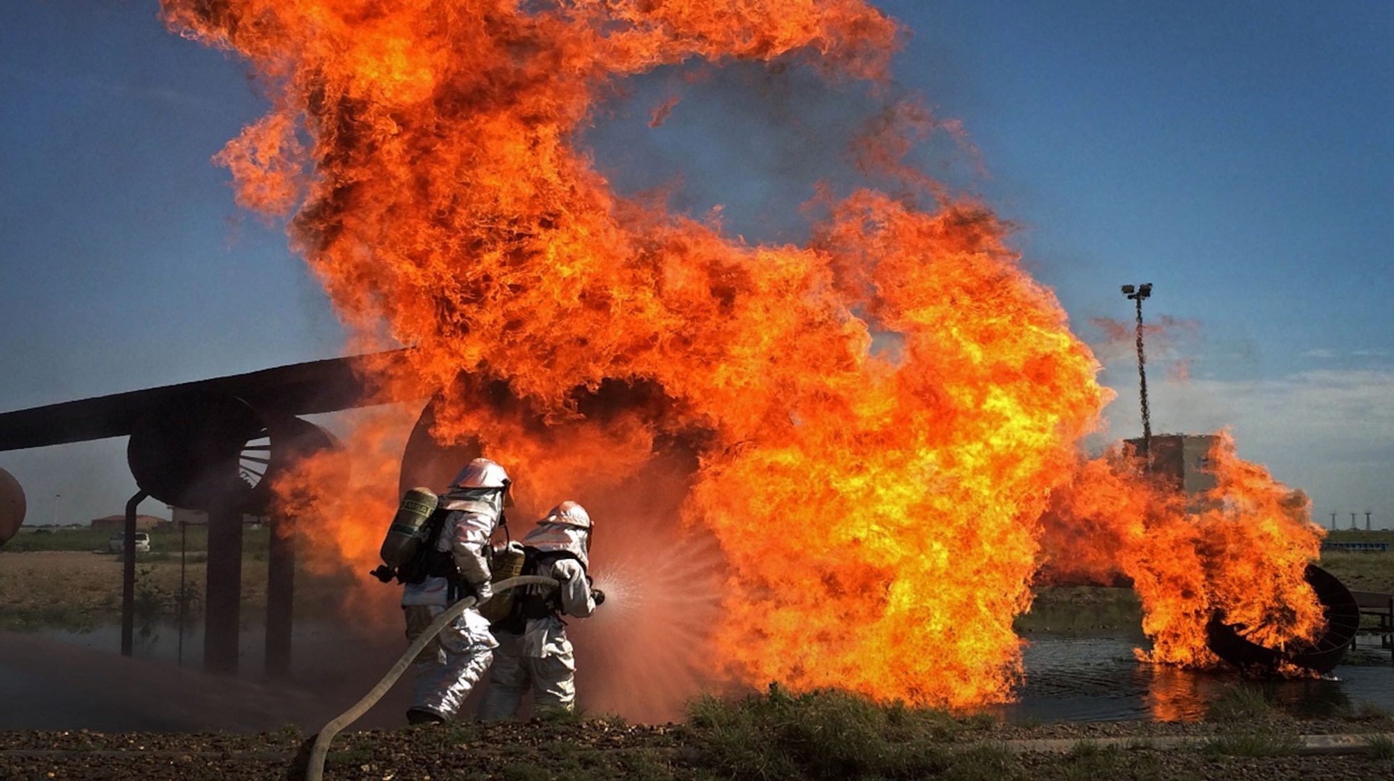 A controlled test-stite burn is put out by fire fighters