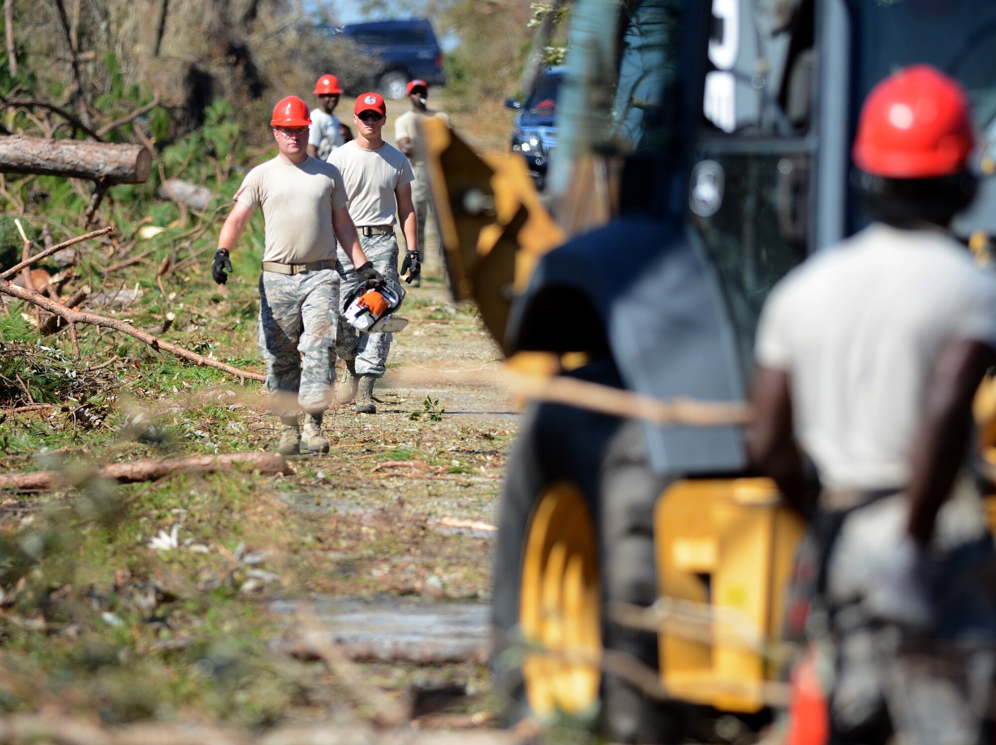 Florida Guardsmen from the 202nd REDHORSE break down fallen trees completely isolating a section of Nadine Road on Oct. 14, 2018 in Panama City, Florida. #HurricaneMichael brought 130 knot winds that uprooted and upended fully grown trees onto roadways all over the area. (U.S. Air National Guard photo by Master Sgt. William Buchanan)