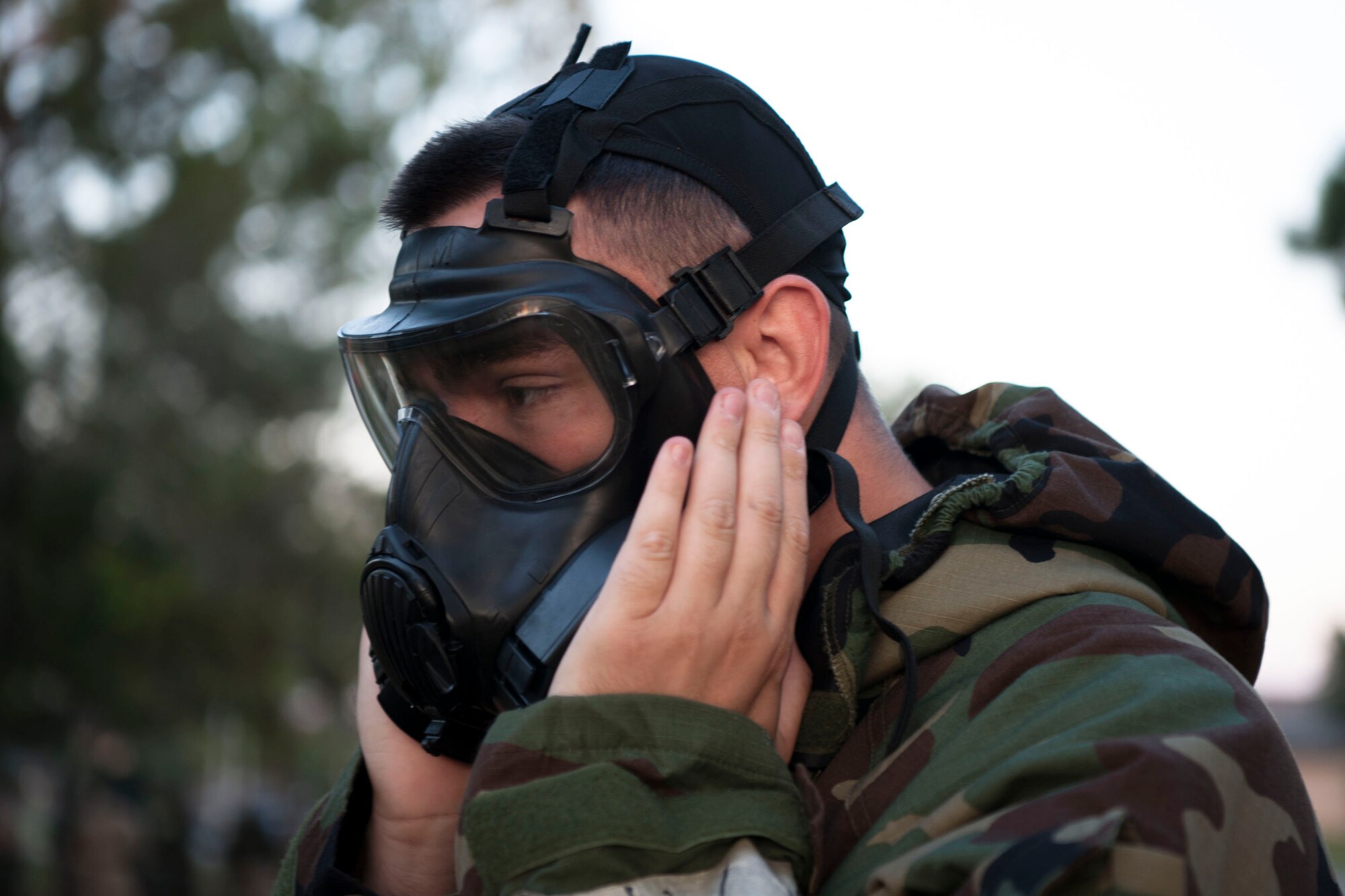 An Airman from the 23d Civil Engineer Squadron secures a gas mask during an Ability to Survive and Operate (ATSO) Rodeo, Sept. 20, 2018, at Moody Air Force Base, Ga. Approximately 2,000 Airmen executed self-aid and buddy care, security and chemical attack avoidance missions under duress in a simulated chemical warfare environment. Testing and enhancing their operational readiness, this prepared the 23d Wing for the upcoming Phase II exercise during Nov. 5-8, 2018, which will be conducted for the first time in seven years. (U.S. Air Force photo by Airman Taryn Butler)