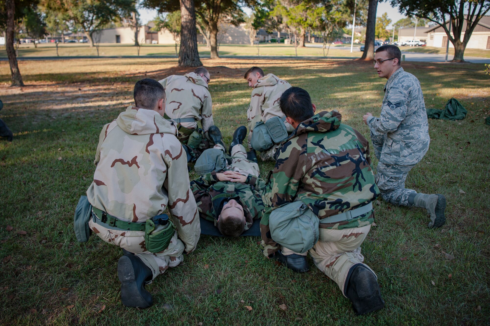 Senior Airman Derek Ketner, far right, 23d Medical Support Squadron medical lab technician, teaches self-aid and buddy care to Airmen from the 23d Civil Engineer Squadron during the Ability to Survive and Operate (ATSO) Rodeo, Sept. 20, 2018, at Moody Air Force Base, Ga. Approximately 2,000 Airmen executed self-aid and buddy care, security and chemical attack avoidance missions under duress in a simulated chemical warfare environment. Testing and enhancing their operational readiness, this prepared the 23d Wing for the upcoming Phase II exercise during Nov. 5-8, 2018, which will be conducted for the first time in seven years. (U.S. Air Force photo by Airman Taryn Butler)