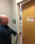 man walks to door notices FPCON Bravo sign