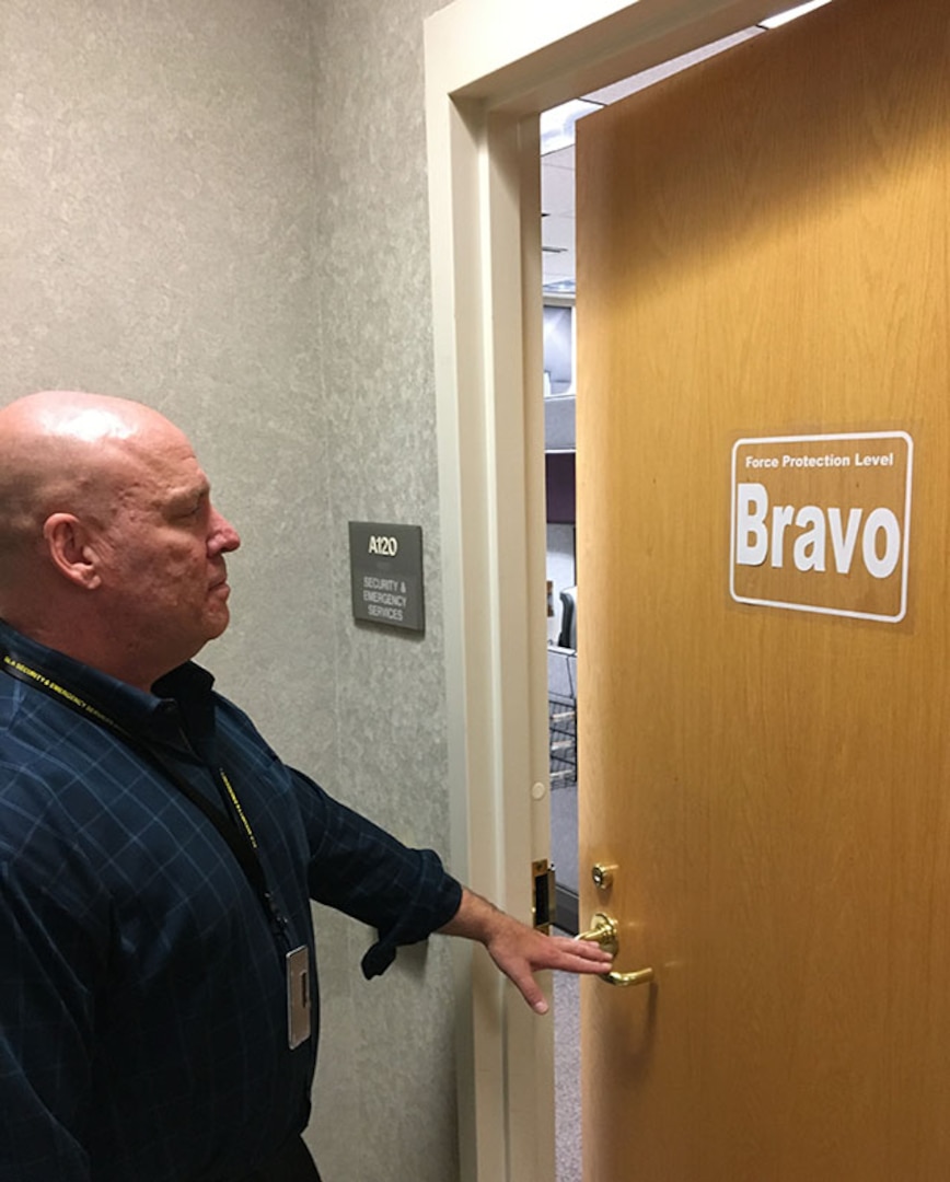 man walks to door notices FPCON Bravo sign