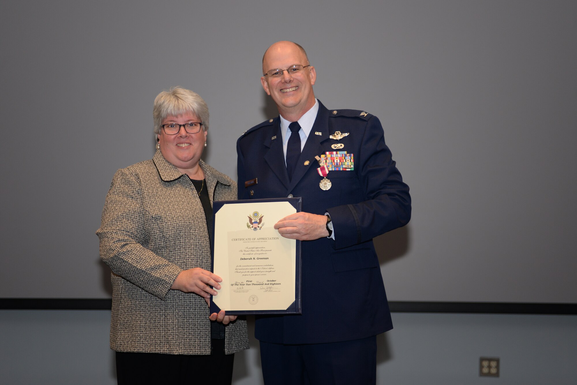 Col John C. Greenan, and is wife, Debrah Greenan, pose for a picture after Mrs. Greenan received her Spouse Appreciation Certificate during her husbands retirement ceremony, Oct 13, 2018 at Pease Air National Guard Base, N.H. (Photo by Staff Sgt. Ashlyn J. Correia N.H. Air National Guard)