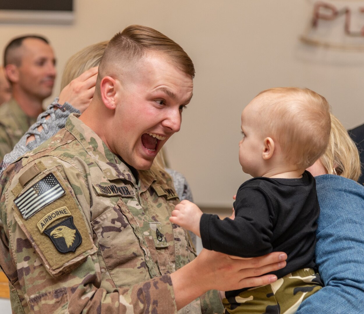 U.S. Army Staff Sgt. Corey Showalter of the 156th Military Police Law and Order Detachment greets his child after returning to Charleston, West Virginia Oct. 10, 2018 following a nine month deployment to Afghanistan. (West Virginia National Guard photo by Bo Wriston)