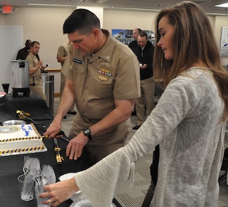 IMAGE: DAHLGREN, Va. (Oct. 12, 2018) - Cmdr. Steven Perchalski cuts the cake for those celebrating the Navy's 243rd birthday at the Naval Surface Warfare Center Dahlgren Division (NSWCDD). NSWCDD will celebrate 100 years of cutting-edge technological innovation in support of the warfighter at a centennial grand finale event Oct. 19 that includes an exhibition tent, a U.S. Navy Band performance, and historic tours featuring six station stops on base.