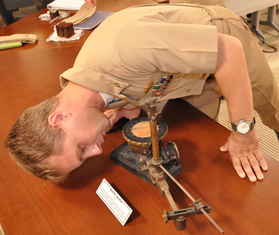 IMAGE: DAHLGREN, Va. (Oct. 12, 2018) - Lt. Adam Mattison examines a World War I bombsight - used to conduct testing at the Dahlgren Naval Proving Ground in the 1920s and 1930s - during a celebration of the Navy's 243rd birthday held at the Naval Surface Warfare Center Dahlgren Division (NSWCDD). The aircraft course-setting bombsight is one of the few surviving examples of the many bombsights tested at Dahlgren. NSWCDD will celebrate 100 years of cutting-edge technological innovation in support of the warfighter at a centennial grand finale event Oct. 19 that includes an exhibition tent, a U.S. Navy Band performance, and historic tours featuring six station stops on base.