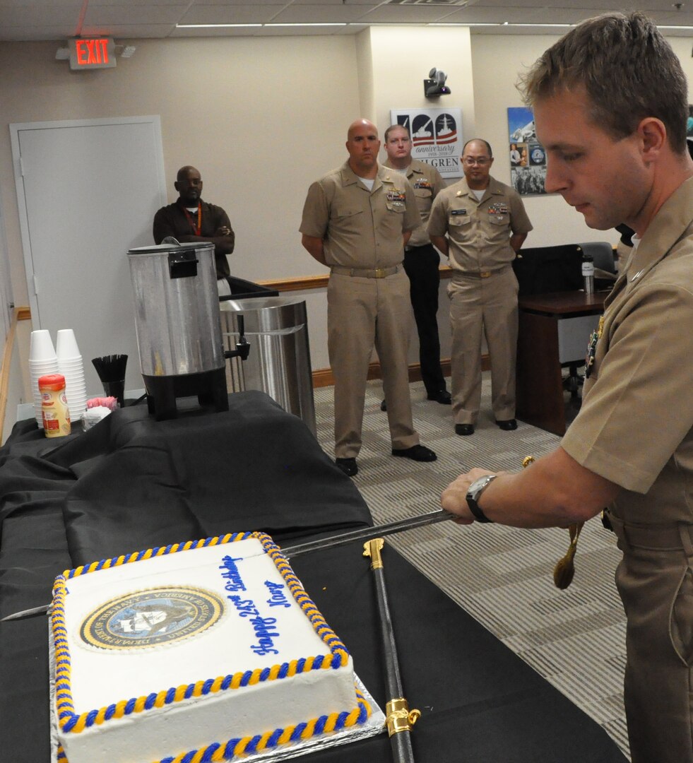IMAGE: DAHLGREN, Va. (Oct. 12, 2018) - Lt. Adam Mattison cuts the cake in celebration of the Navy's 243rd birthday at Naval Surface Warfare Center Dahlgren Division (NSWCDD). The event featured Mattison as the command's youngest 
Sailor cutting the Navy's birthday cake with the command's oldest Sailor, Cmdr. Steven Perchalski. The Navy birthday cake-cutting ceremony is important to all Sailors, as it is an annual renewal of each Sailor's commitment to the Navy and 
the Navy's commitment to our nation's quest for peace and freedom worldwide. Perchalski and Mattison cut the cake with a sword, a traditional reminder that NSWCDD Sailors are among a band of warriors, committed to carrying arms 
so that the United States and its people may live in peace.