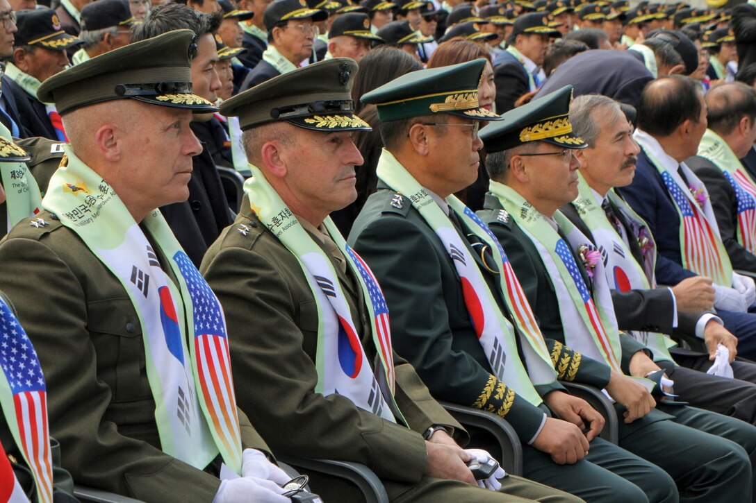 Maj. Gen. Patrick J. Hermesmann, U.S. Marine Corps Forces Korea commander (left), Maj. Gen. James W. Lukeman, U.S. Forces Korea J-5 Strategy (center-left), senior leaders from the Republic of Korea, and the honorable Harry Harris, U.S. ambassador to the R.O.K. (right), observe the commemoration for the 68th anniversary of the Battle of Chosin Reservoir in Seoul, Oct 10.  MARFORK works with the Republic of Korea Ministry of Patriots and Veterans Affairs via the U.S. Forces Korea Good Neighbor Program to honor the shared heritage of the U.S. and R.O.K.