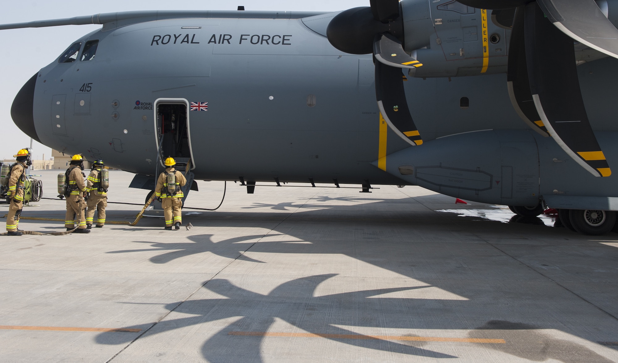 U.S. Air Force firefighters from the 379th Expeditionary Civil Engineer Squadron prepare to extinguish a “burning” Royal Air Force A400M Atlas aircraft during Atlas Mountain  at Al Udeid Air Base, Qatar, Oct. 16, 2018.