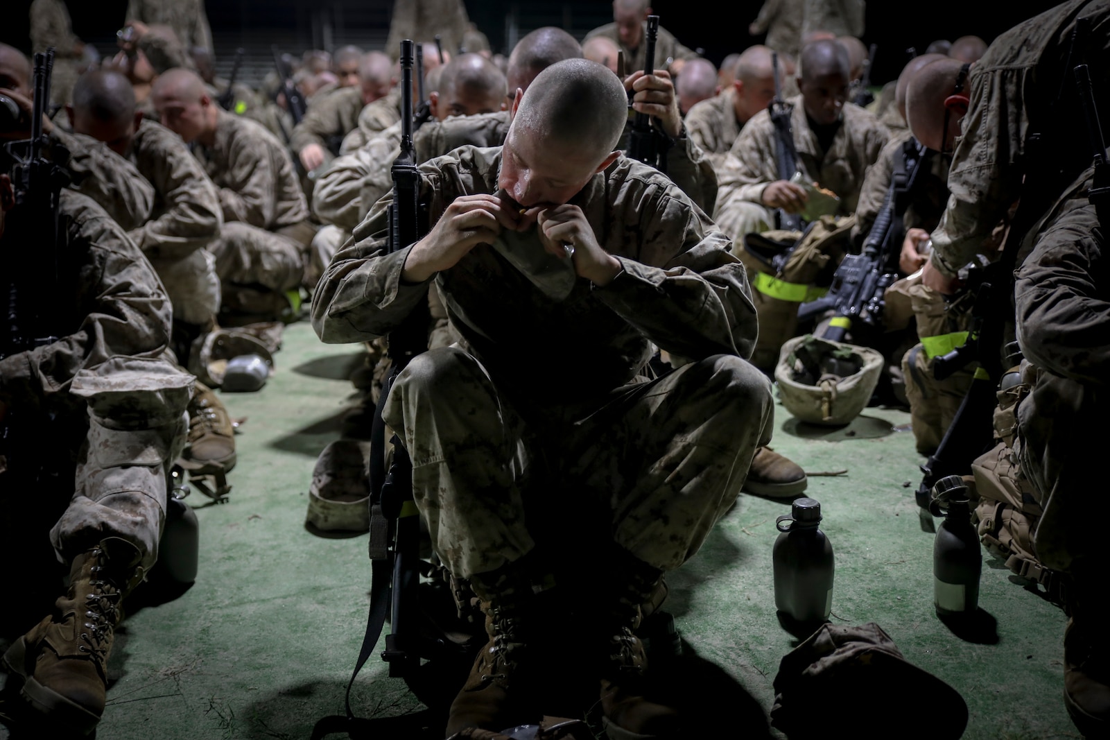 Recruits with Delta Company, 1st Recruit Training Battalion, eat a "Meal-Ready-To-Eat" during the Crucible on Marine Corps Recruit Depot Parris Island, S.C., Sept. 27, 2018. The Crucible is a 54-hour culminating event that requires recruits to work as a team and overcome challenges in order to earn the title United States Marine. (U.S. Marine Corps photo by Lance Cpl. Shane T. Manson)