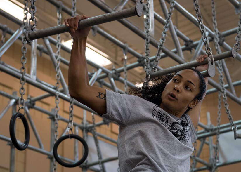 U.S. Air Force 1st Lt. Nicole Mitchell, 83rd Network Operations Squadron crew commander, swings across the broken bars during the Alpha Warrior Northeast Regional Competition at Joint Base Langley-Eustis, Virginia, Oct. 13, 2018.