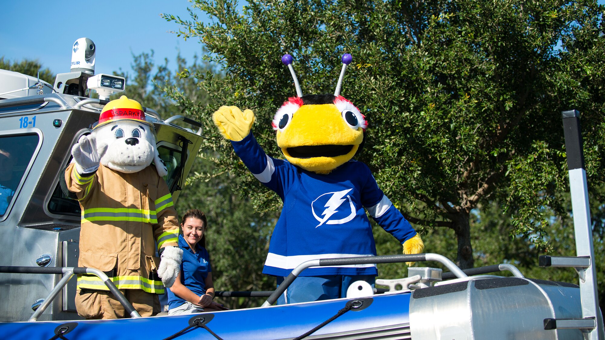 ThunderBug, the mascot for the Tampa Bay Lightning, and Sparky, the 6th Civil Engineer Squadron fire protection mascot, ride a towed marine patrol boat at MacDill Air Force Base, Fla., Oct. 13, 2018.