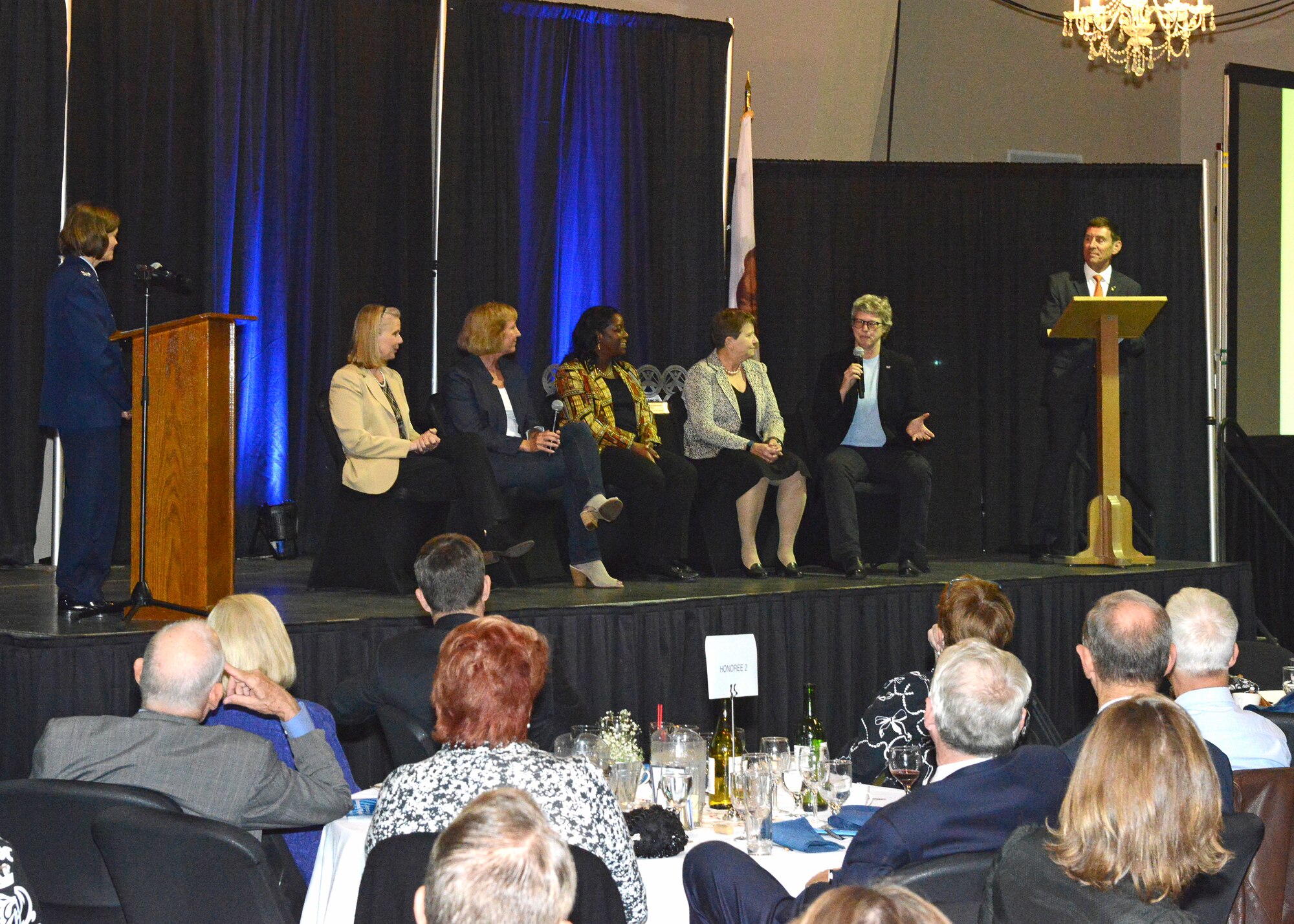 Bill Gray, U.S. Air Force Test Pilot School chief test pilot (far right), emceed the annual Gathering of Eagles event hosted by the Flight Test Historical Foundation Oct. 13 at the Antelope Valley Fairgrounds. Following dinner service and a silent auction, Col. Angela Suplisson, Air Force Test Center vice commander (far left), moderated a question and answer panel with the eagles. From left to right, the panel of eagles are: Dr. Sandy Miarecki, Kelly Latimer, Laurie Grindle, Dr. Eileen Bjorkman and Cynthia Bixby. (U.S. Air Force photo by Kenji Thuloweit)