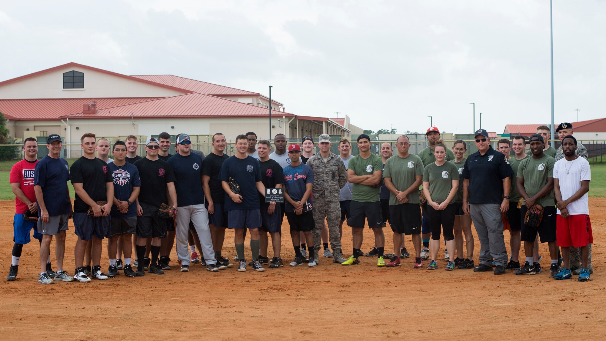 Participants in the 2018 Battle of the Badges softball game between the 6th Civil Engineer Squadron firefighters and the 6th Security Forces Squadron defenders pause for a group photo at MacDill Air Force Base, Fla., Oct. 10, 2018.