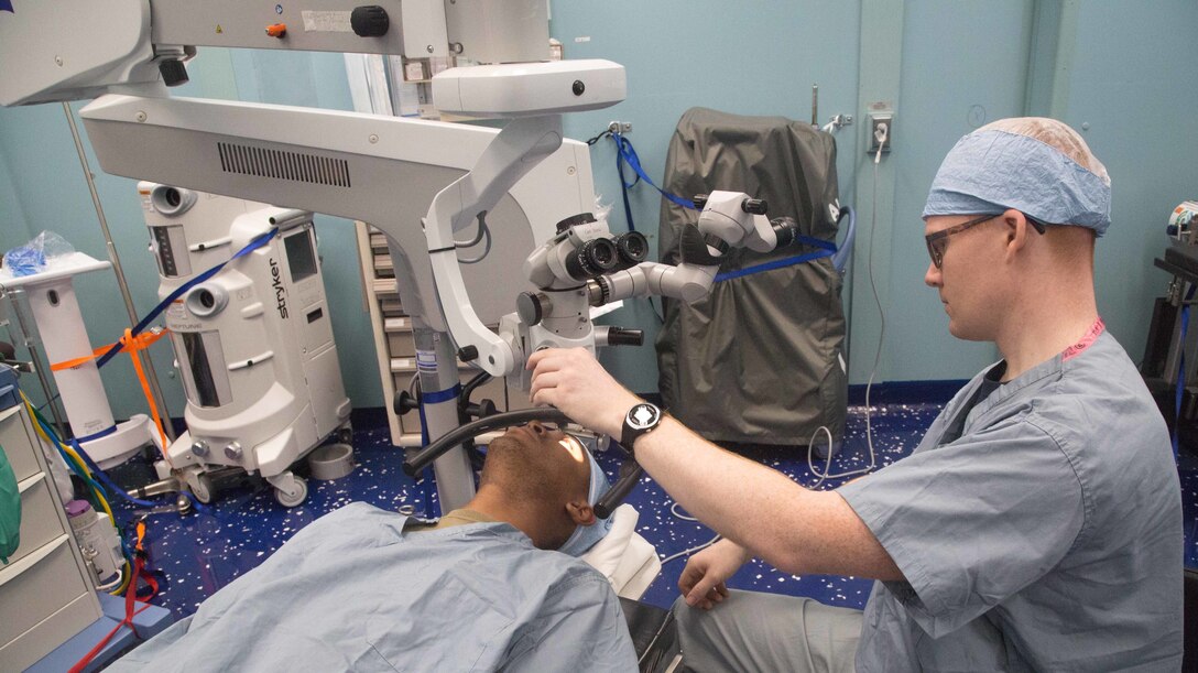 A U.S. Navy Hospital Corpsman performs an eye exam aboard the hospital ship USNS Comfort.