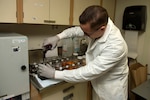 Hospital Corpsman 3rd Class Michael Murphy, from Crestline, Calif., prepares a testing agent to test skin samples for diseases aboard the hospital ship USNS Comfort.